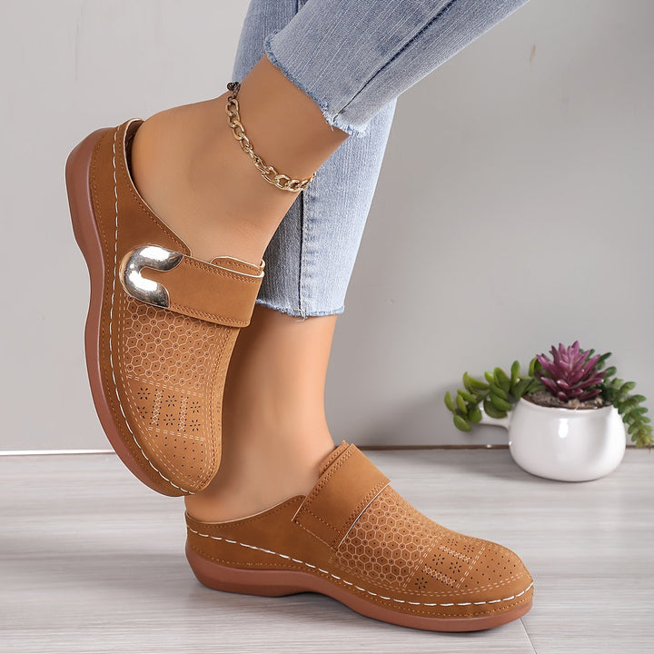 Comfortable women's house slippers with ergonomic arch support. Soft, cushioned, and non-slip for indoor wear.