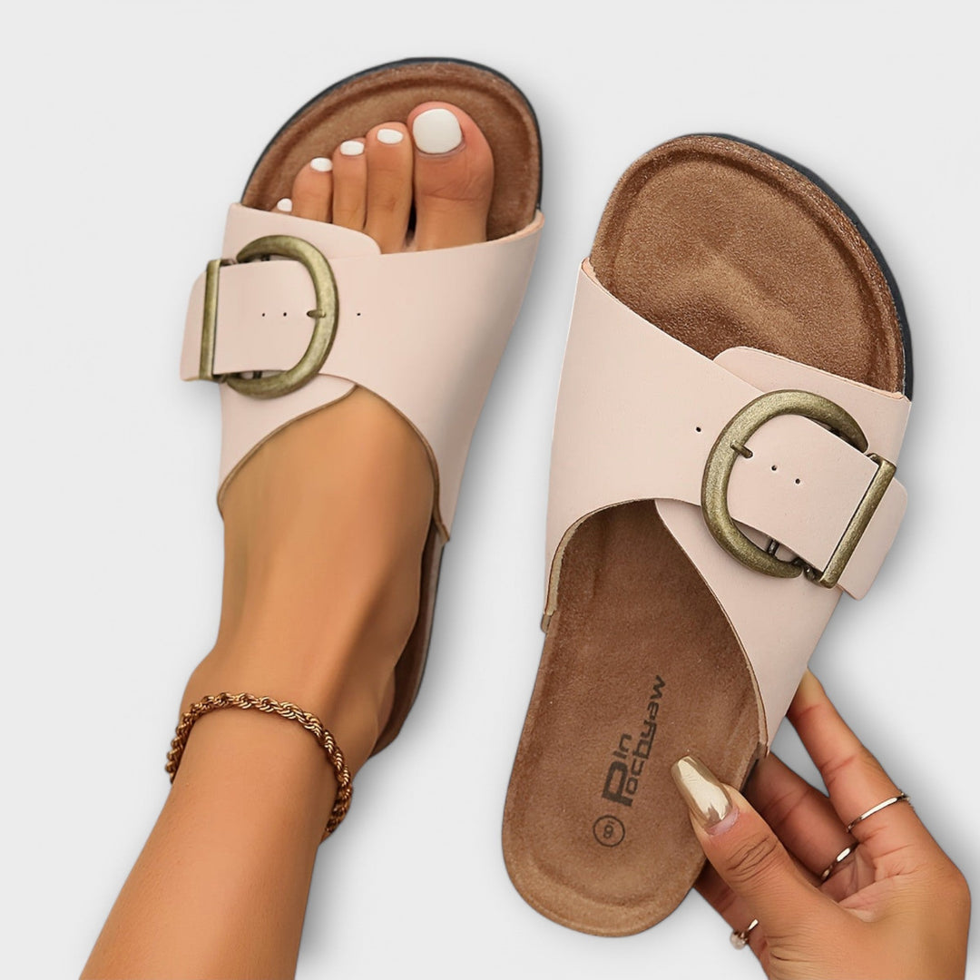 Adjustable women's slide sandals with ergonomic footbed, providing orthopedic support and comfort.