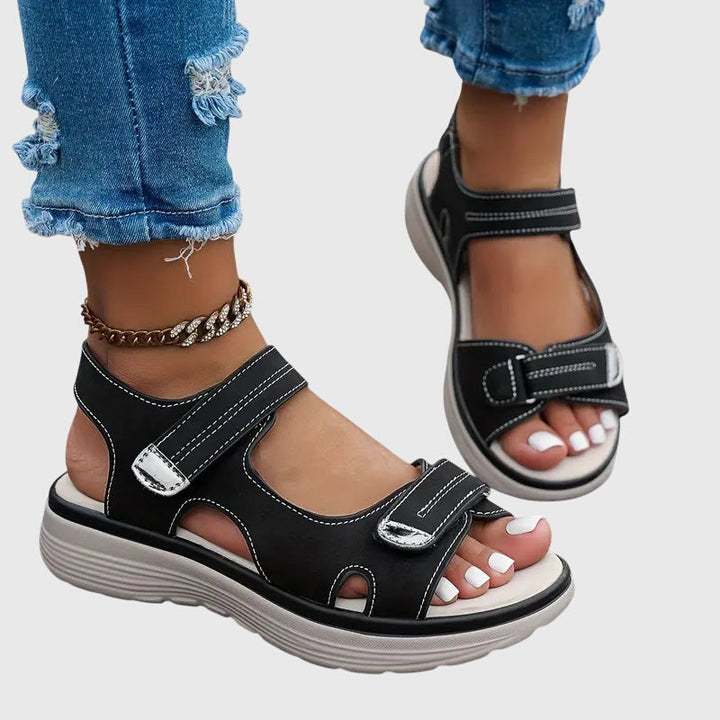 Close-up of orthopedic sandals sole, highlighting arch support & ergonomic design for pain relief.