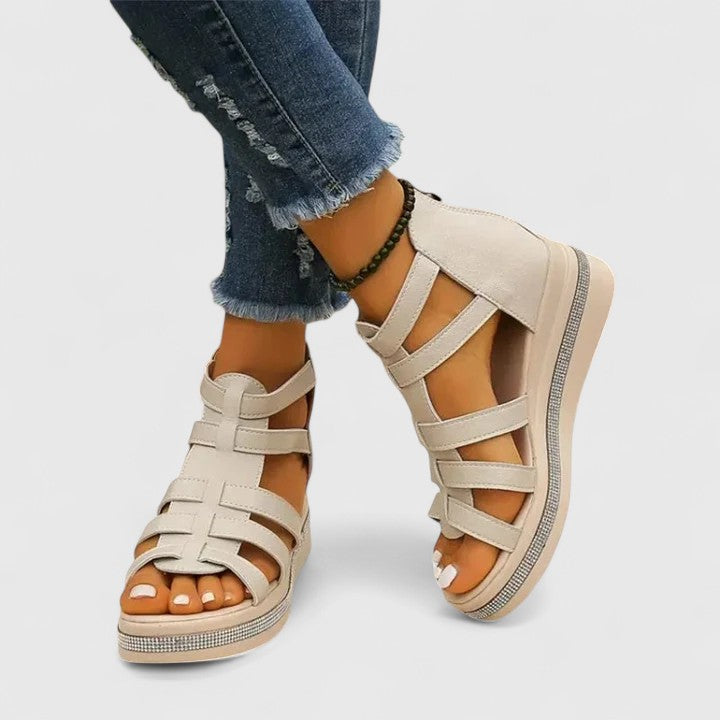 Women's stylish orthopedic sandals with a comfortable wedge heel, adorned with beautiful rhinestones.