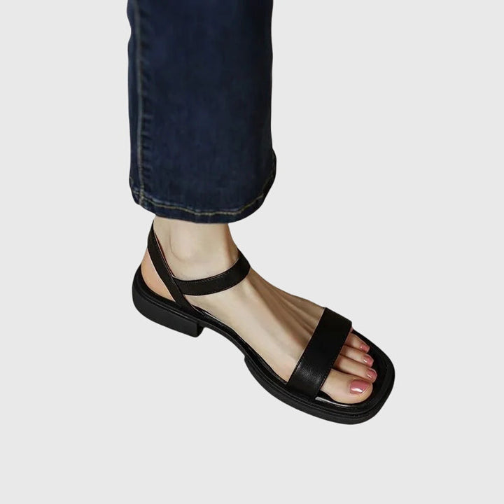Close-up of women's orthopedic comfort sandals, showing soft straps & supportive block heel. Stylish casual summer footwear.