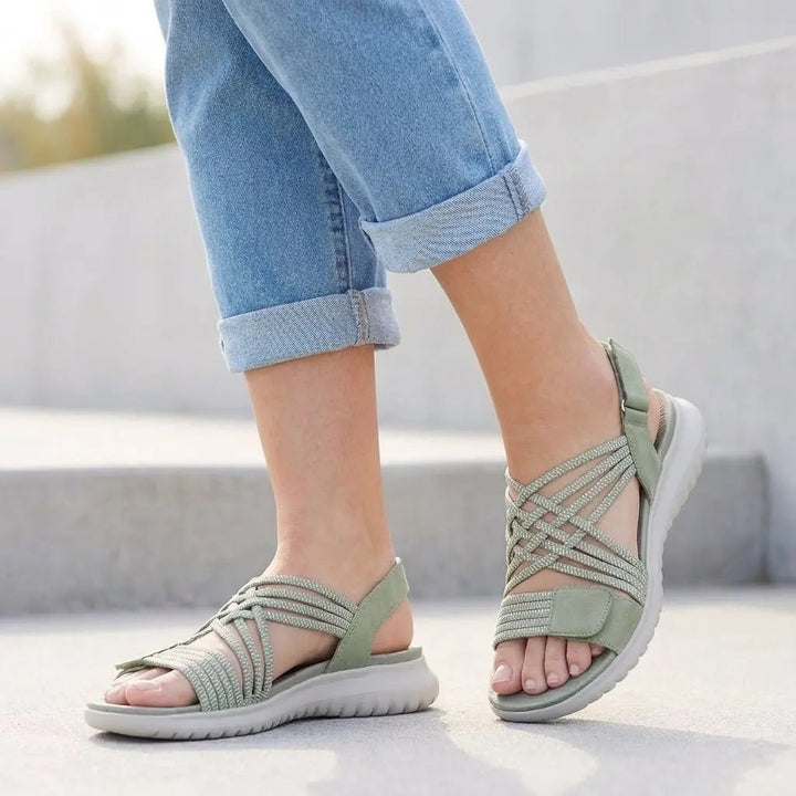 Women's orthopedic criss-cross sandals with adjustable straps & arch support for ultimate comfort & foot health.