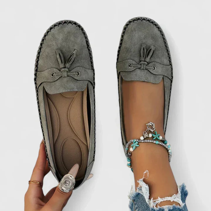 Detailed view of women's orthopedic loafers with sophisticated tassel & bow accents, highlighting craftsmanship.
