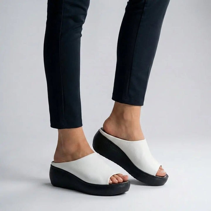 Fashionable women's platform slide sandals, open-toe design, offering comfortable arch support. Ideal summer slip-on.