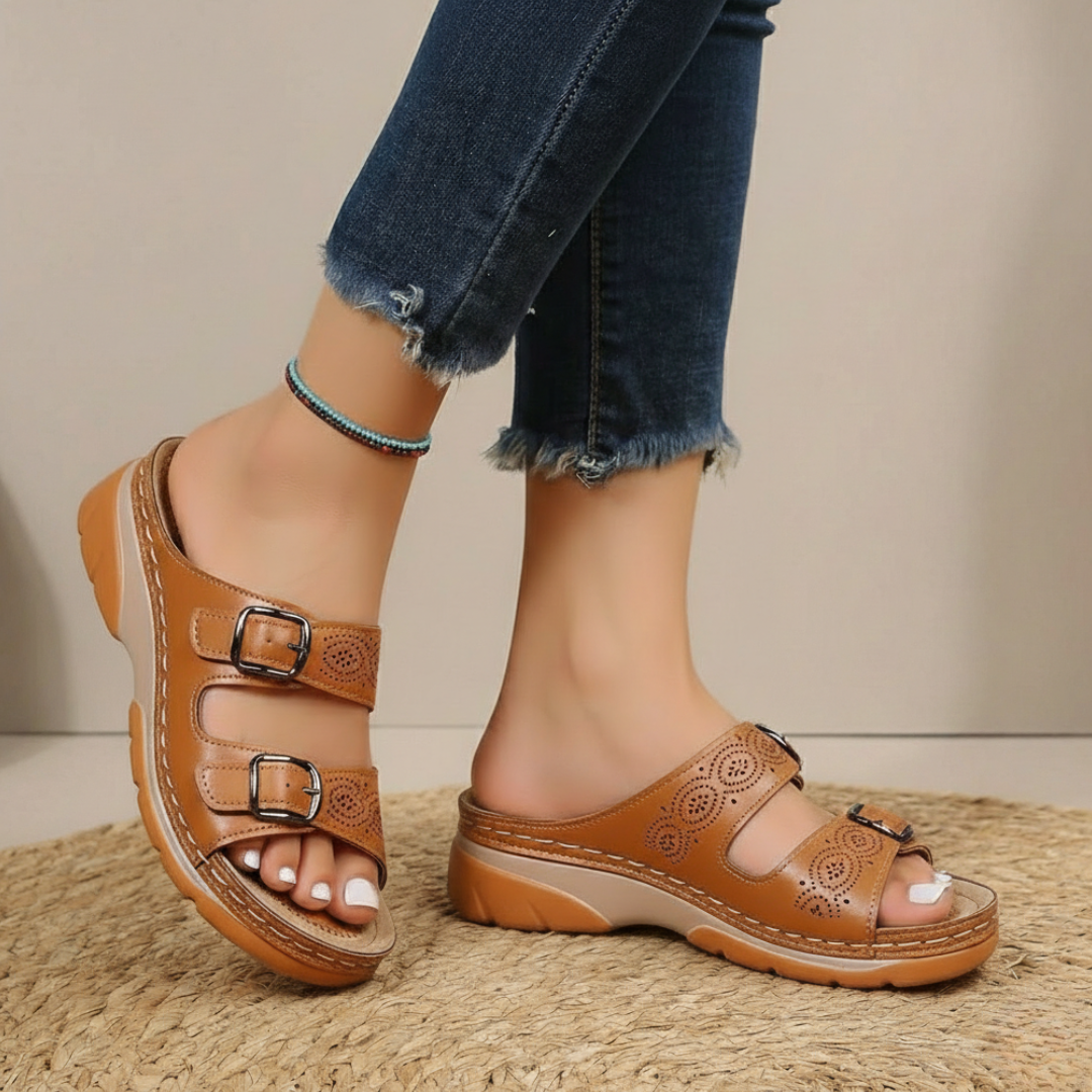 Women's orthopedic slides with intricate laser-cut detailing for breathable summer comfort.