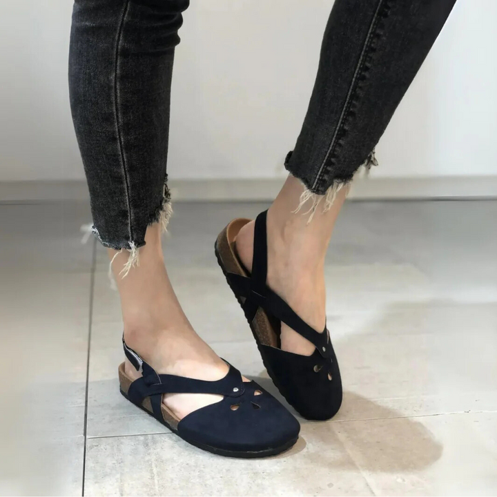 Women's closed-toe orthopedic slingback sandals featuring secure cross-straps and supportive arch for comfort.