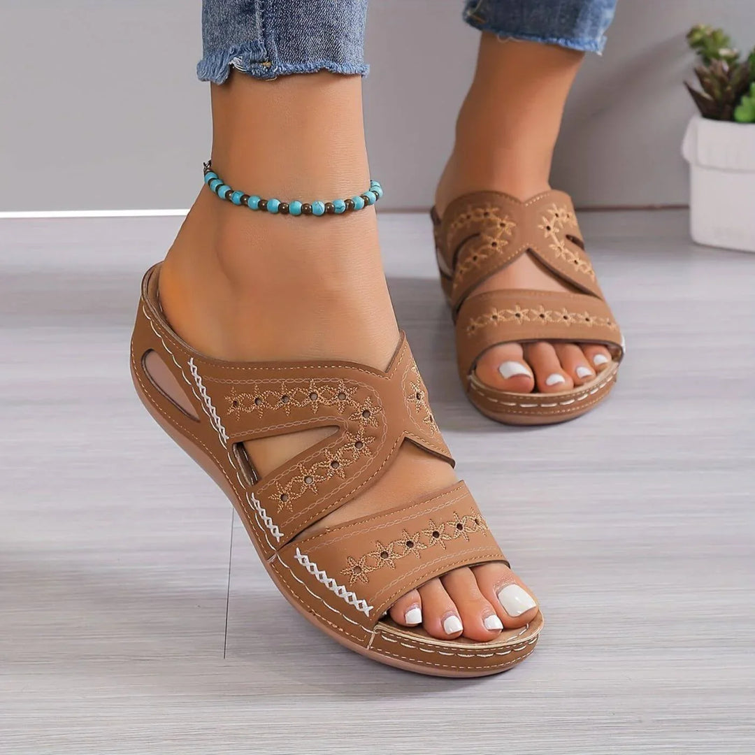 Comfortable women's orthopedic slip-on sandals with arch support & anti-slip grip.