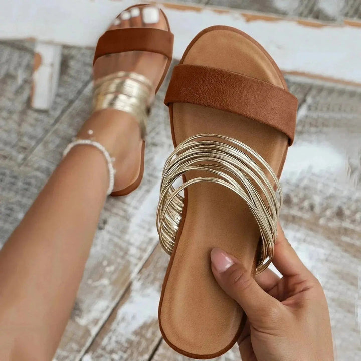 Stylish women's slip-on orthopedic sandals with metallic straps, lightweight & supportive for daily wear.