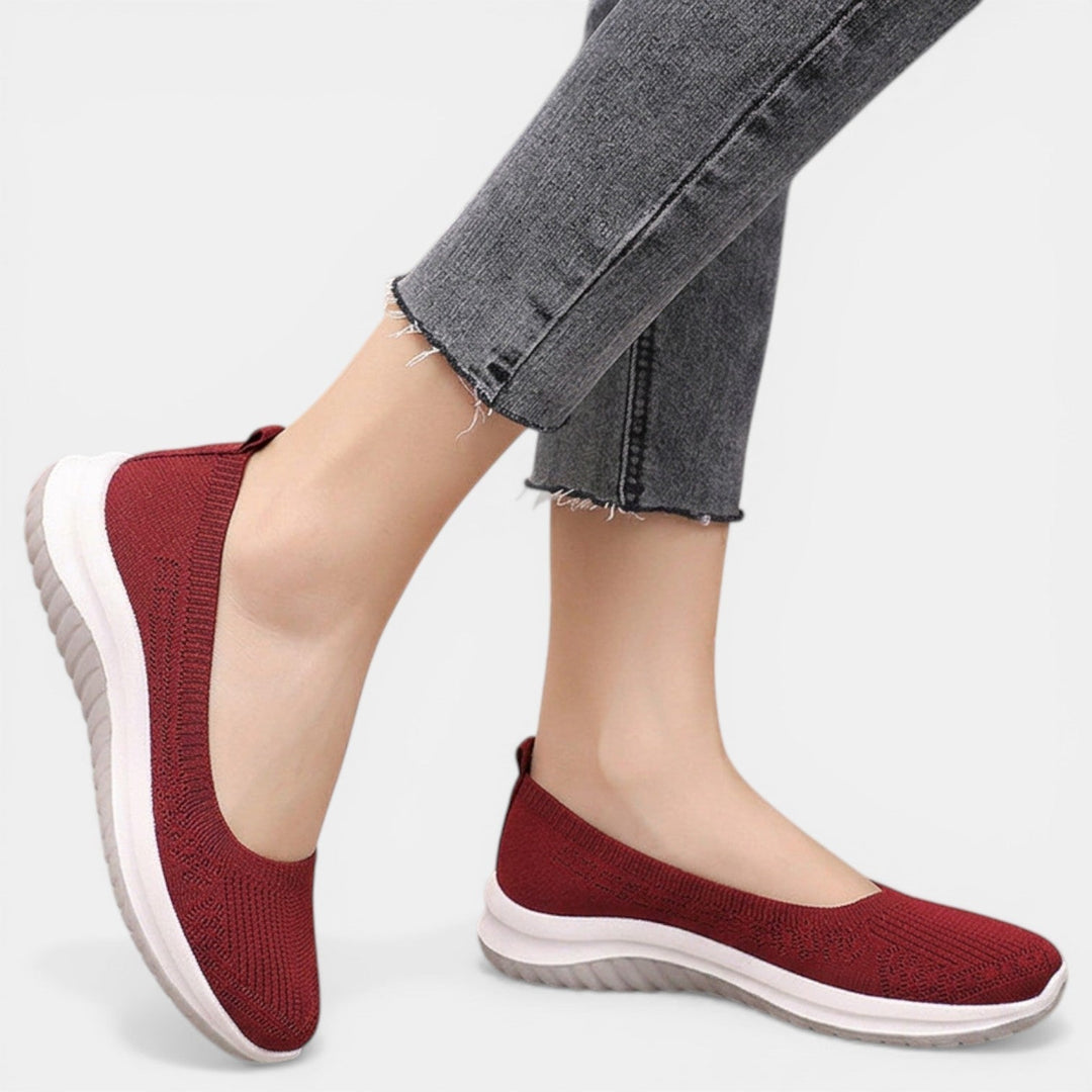 Woman walking in comfortable slip-on orthopedic sneakers, ideal for daily wear & active lifestyle.