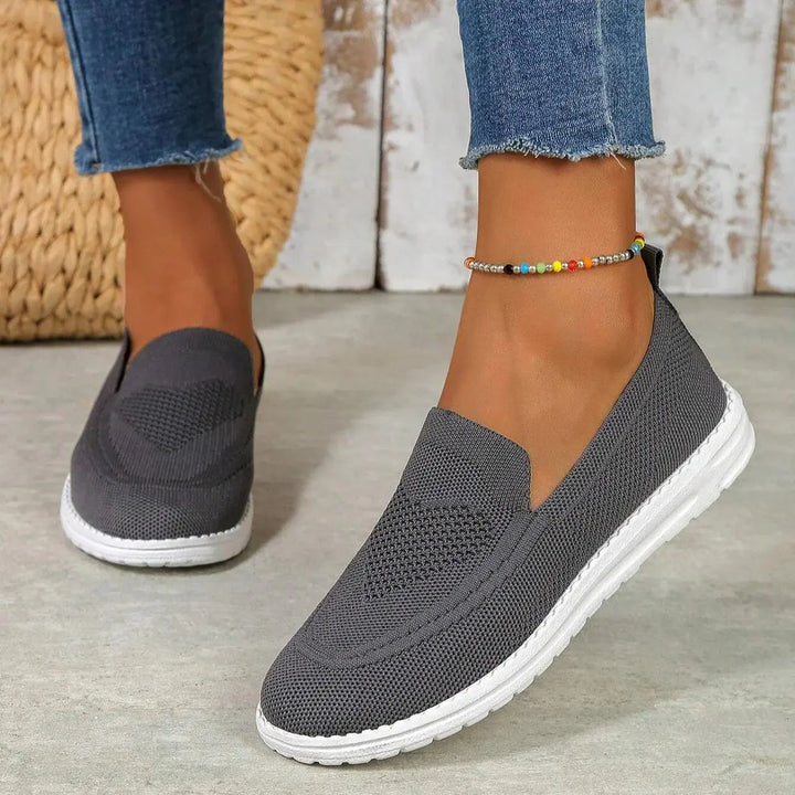 Cushioned women's slip-on walking trainers, offering orthopedic arch support for comfortable active wear.