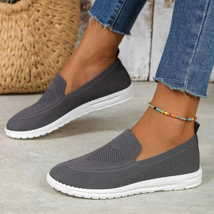 Convenient slip-on women's trainers with robust orthopedic arch support & cushioning for easy daily wear.