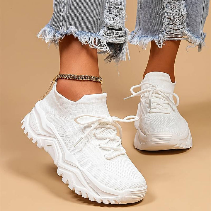 Women's orthopedic sneakers in white, offering superior arch support and comfort for daily wear.