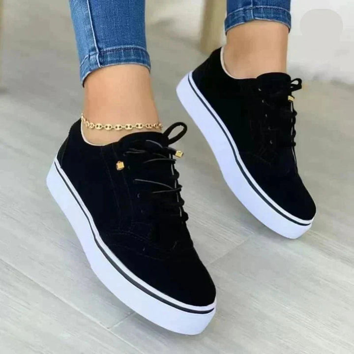 Lace-up women's walking sneakers designed for foot pain relief, featuring strong arch support and comfort.