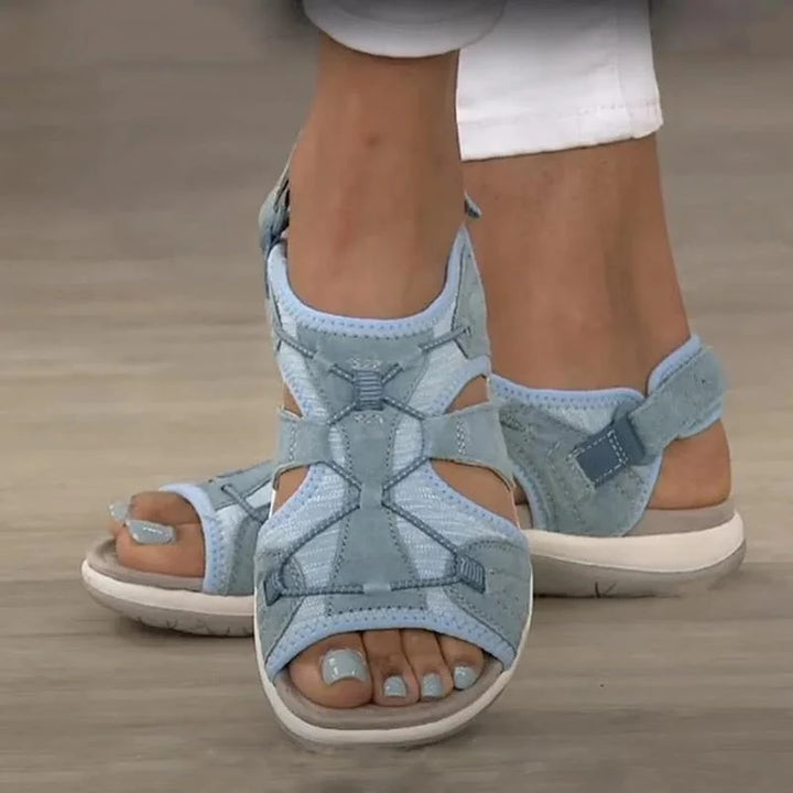 Comfortable women's walking sandals with arch support, adjustable straps & decorative cut-outs for summer.