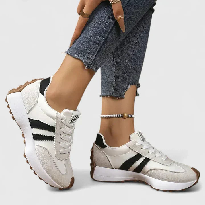 Close-up of women's comfortable trainers highlighting advanced arch support and cushioned sole.