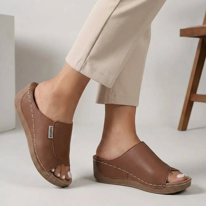 Comfortable women's orthopedic open toe slip-on sandals with a supportive wedge heel.