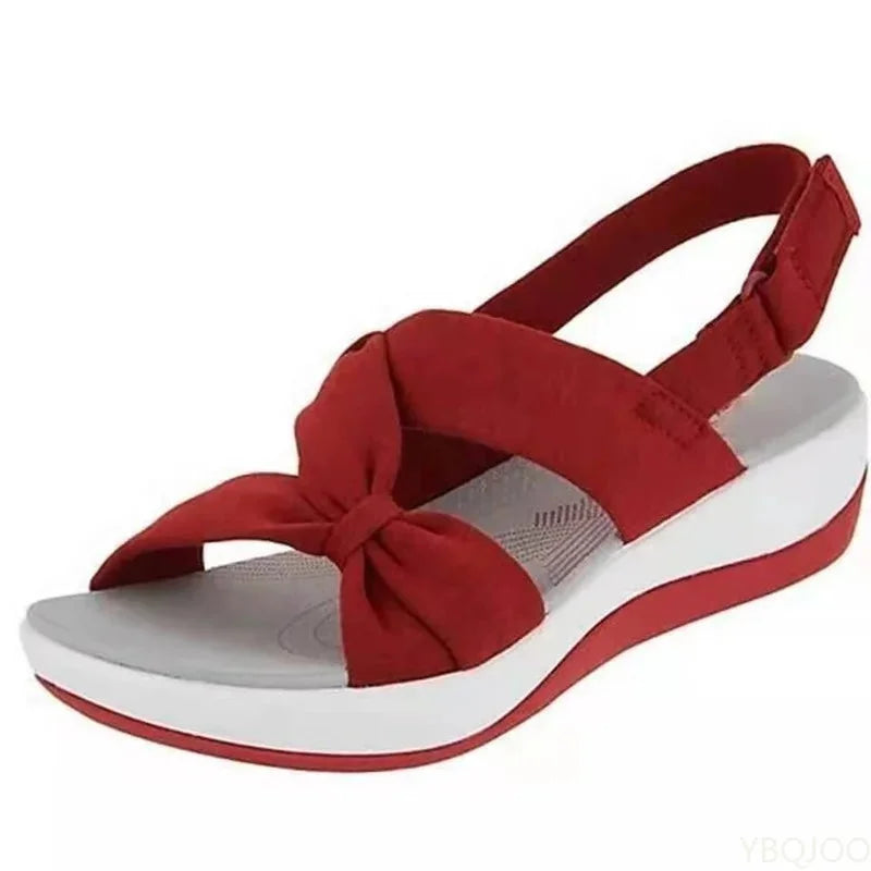 Comfortable women's orthopedic wedge sandals, providing arch support & foot health with an adjustable strap.