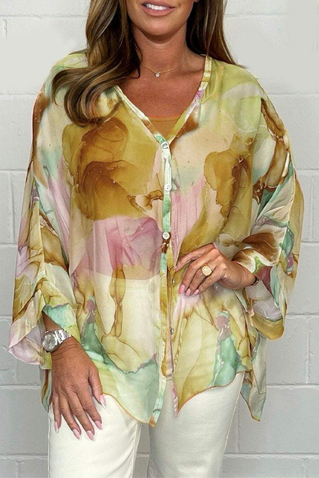 Women's oversized abstract print blouse with v-neck, long sleeves, and button-down front. Stylish & modern fashion top.