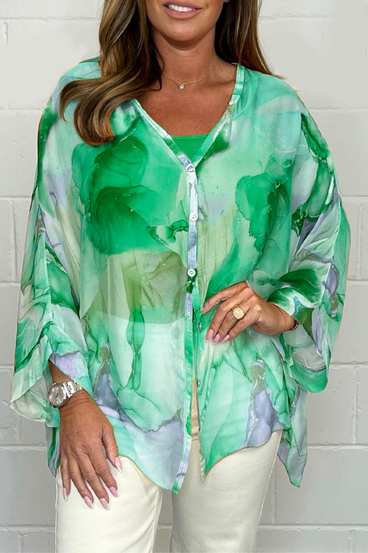 Oversized women's blouse with an eye-catching abstract print, v-neck, long sleeves. Perfect for casual chic fashion.
