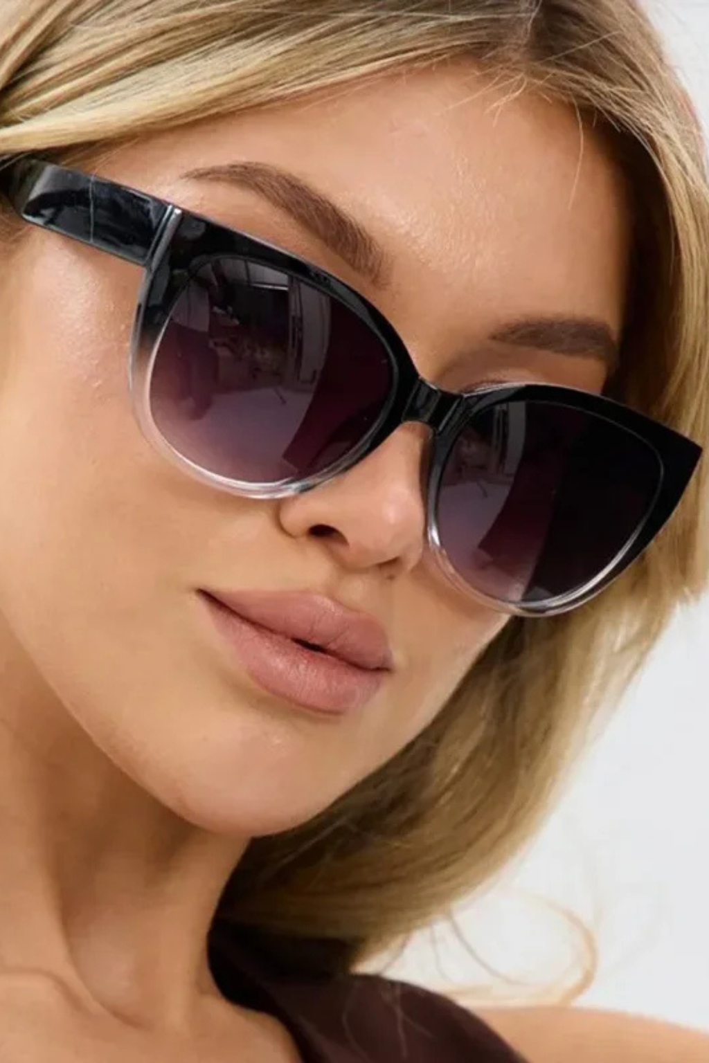 Black oversized cat-eye sunglasses for women, featuring trendy gradient tinted lenses for a chic look.