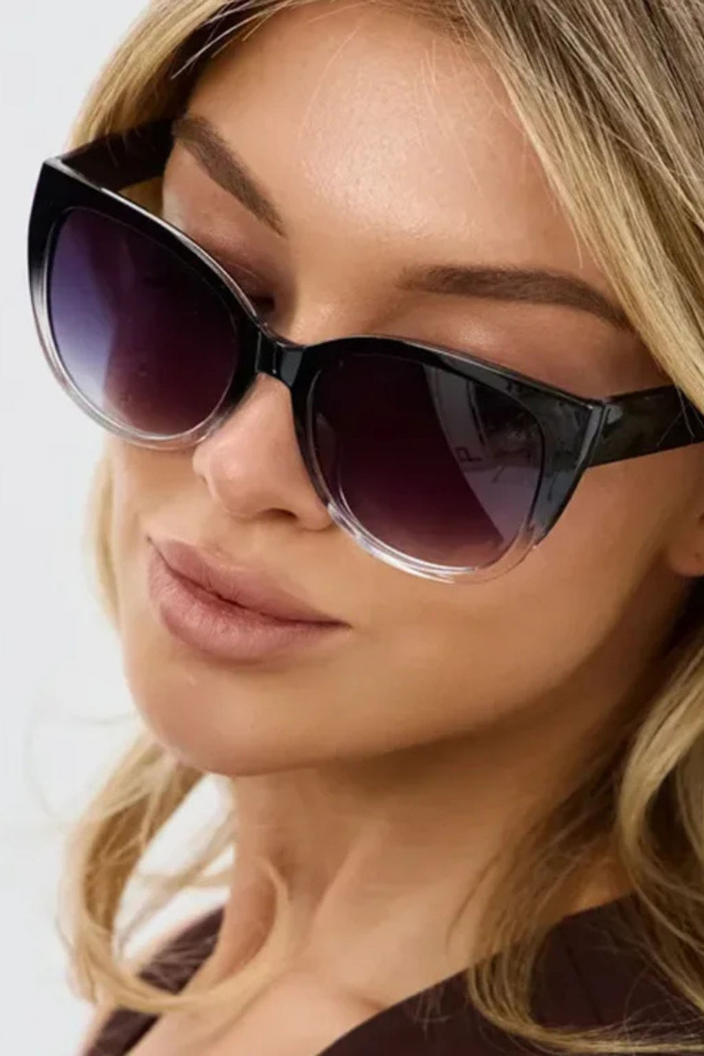 Fashionable women's oversized black cat-eye sunglasses with gradient lenses, offering stylish eye protection.