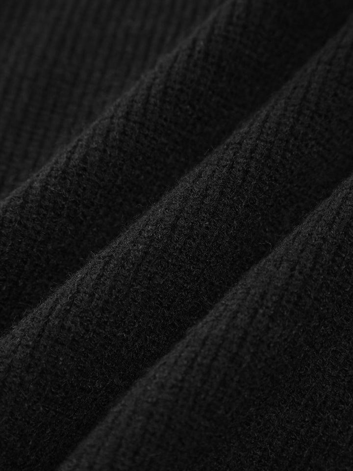Trendy women's oversized black sweater with modern contrast-stitch design, a warm mock neck, perfect for fall fashion.