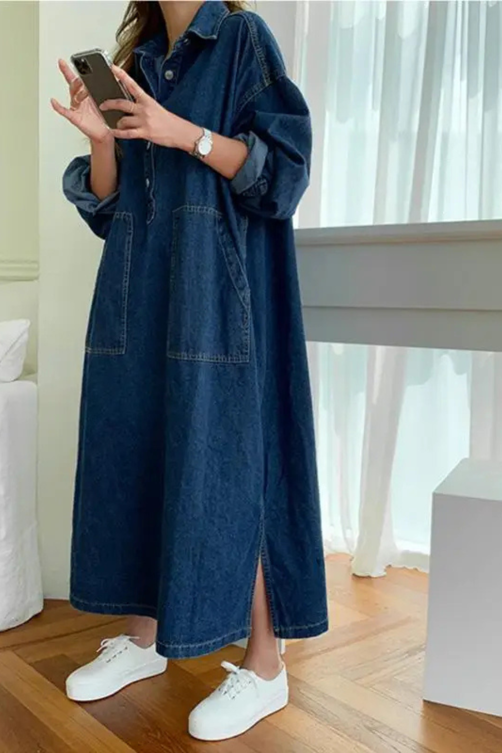 Stylish women's collared oversized denim maxi dress. Comfortable blue long sleeve design with handy pockets for everyday wear.