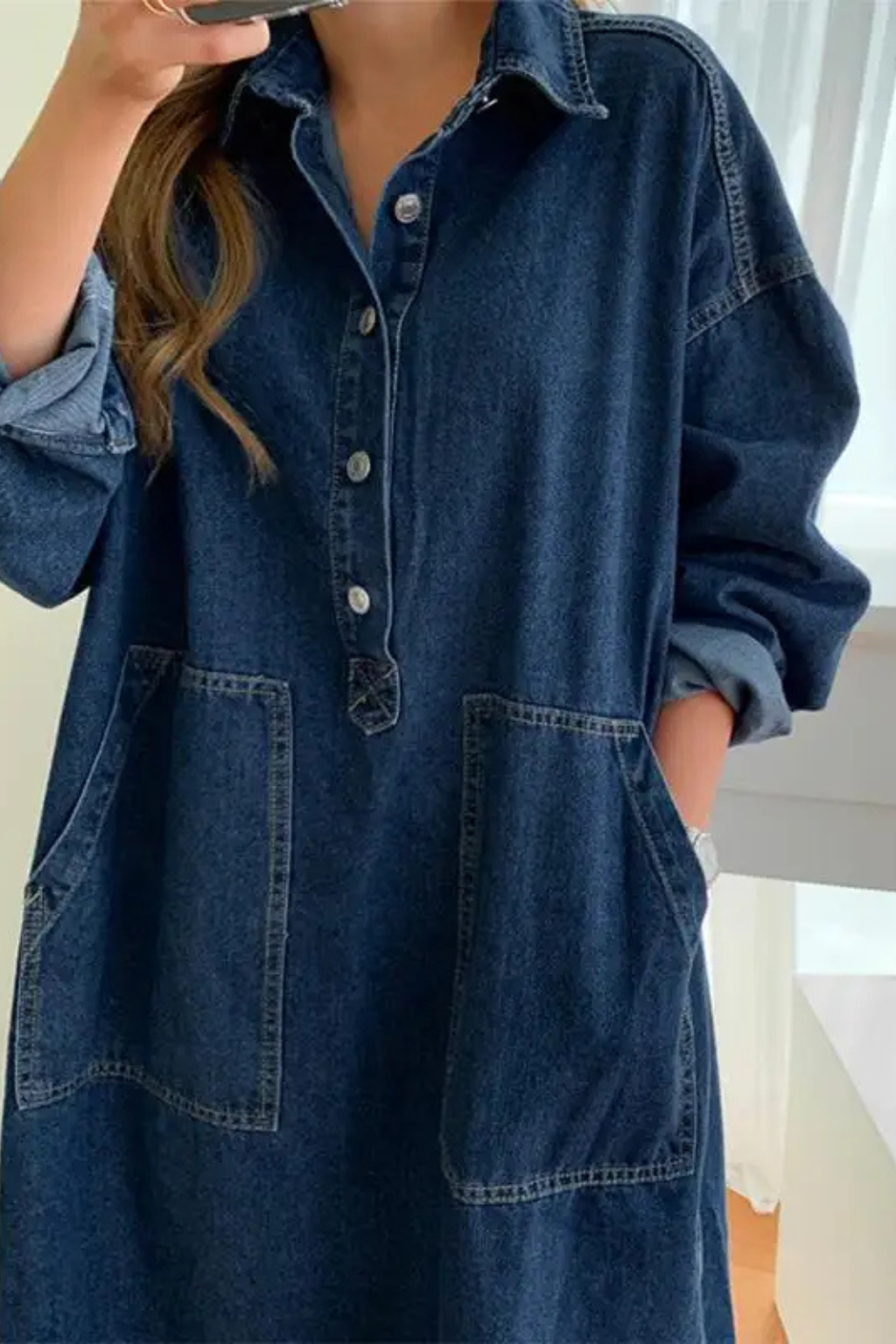 Versatile women's oversized blue denim maxi dress. Collared, long sleeve, with pockets; ideal for comfortable, stylish everyday wear.