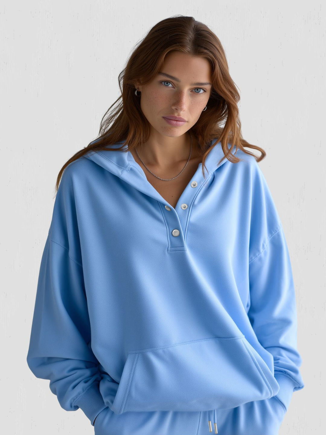 Cozy women's loungewear hoodie featuring a stylish oversized design and snap-fit closure.