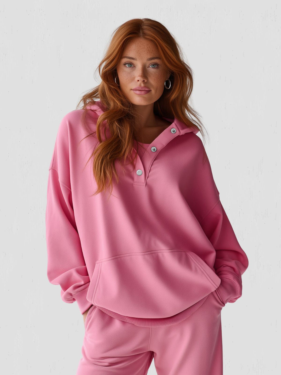 Oversized snap-fit hoodie for women, made from soft cotton for relaxed, casual wear.