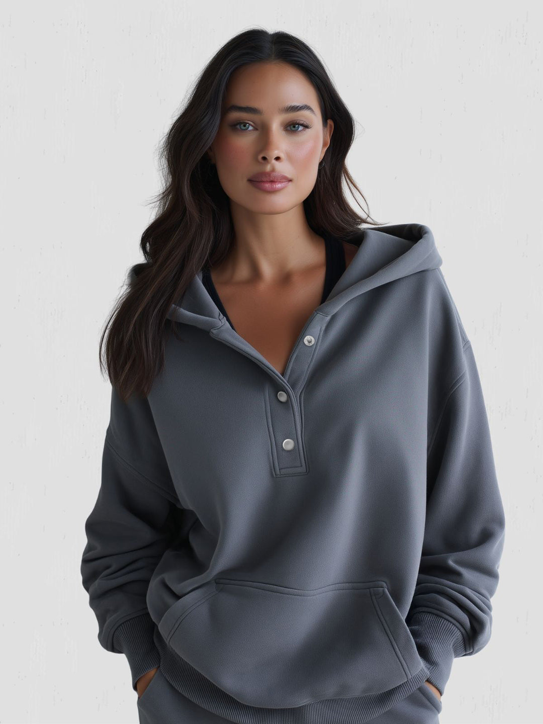 Comfort wear essential: women's oversized snap-fit hoodie for a laid-back look.