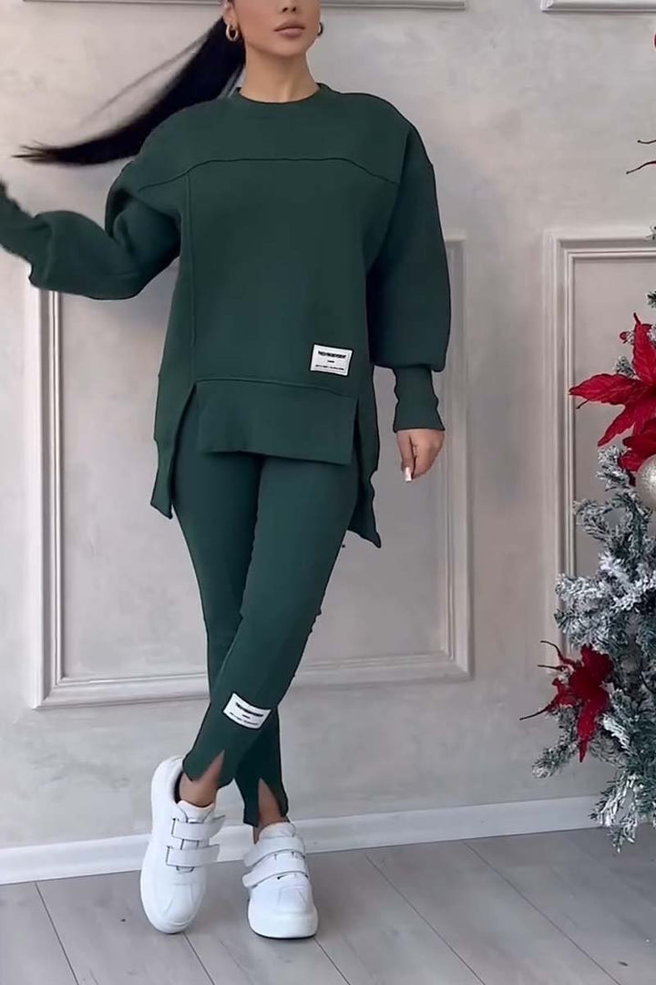 Woman relaxing in a comfortable oversized loungewear set; crew neck long sleeve top & leggings for cozy days.