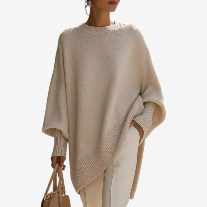 Women's oversized crew neck sweater with batwing sleeves & asymmetric hem. Perfect for casual, chic fall fashion.