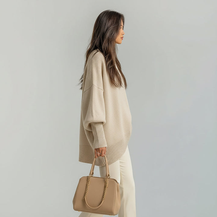 Oversized women's sweater with batwing sleeves, crew neck, and asymmetric hem. Casual, comfortable, fall style.