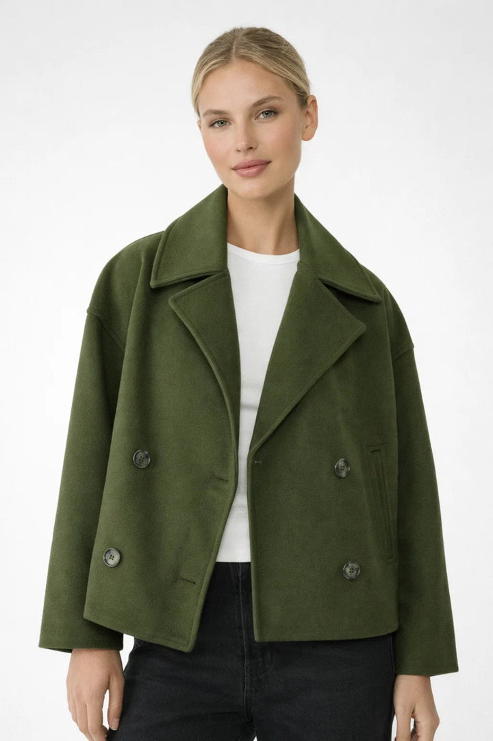 Fashionable women's double-breasted short coat. This oversized jacket offers a chic smart casual look.