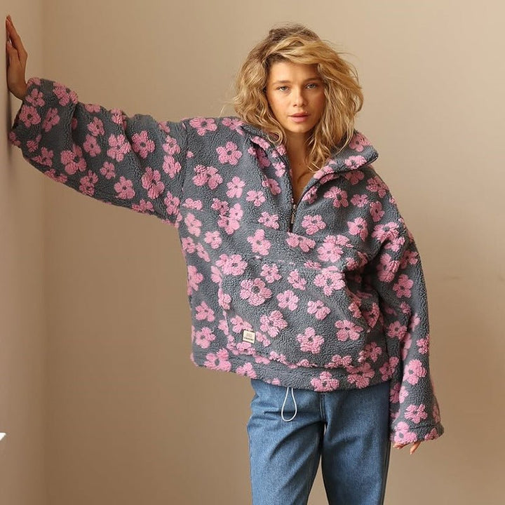 Long sleeve, hip-length women's floral half-zip sweater jacket, oversized for a relaxed fit.