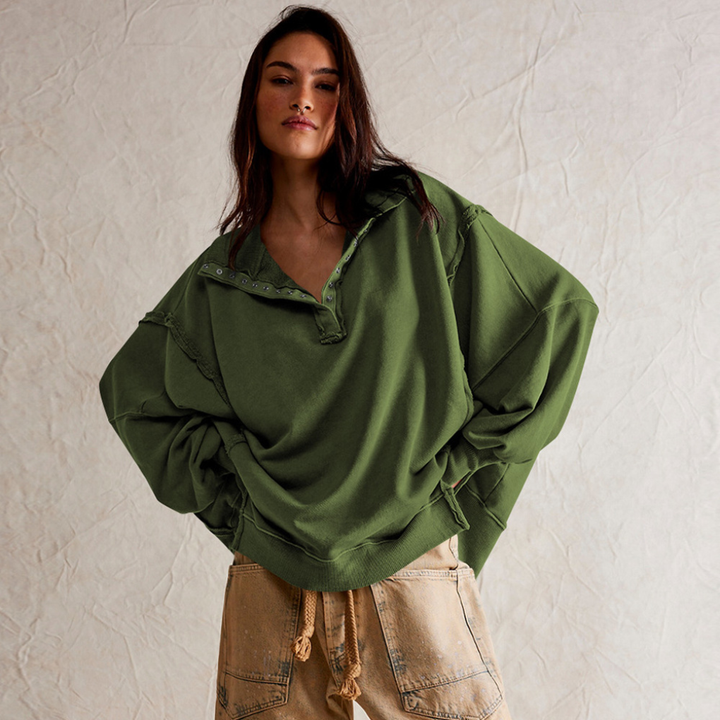 Stylish women's oversized henley pullover with buttons, featuring a relaxed long-sleeve design for casual wear.