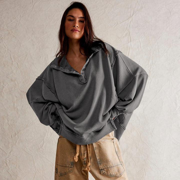 Women's apparel: oversized henley pullover, a relaxed long-sleeve top designed for comfortable casual wear.