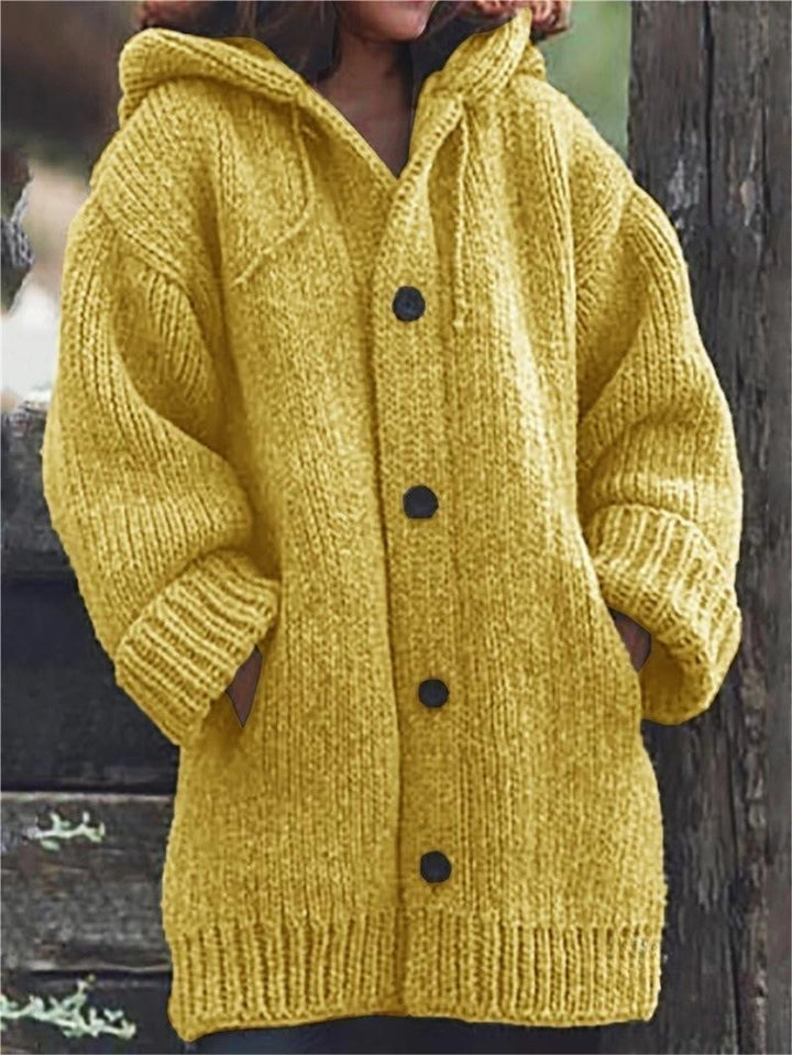 Women's oversized knit hooded cardigan. Cozy, stylish long-sleeve knitwear with pockets for fall & winter layering.