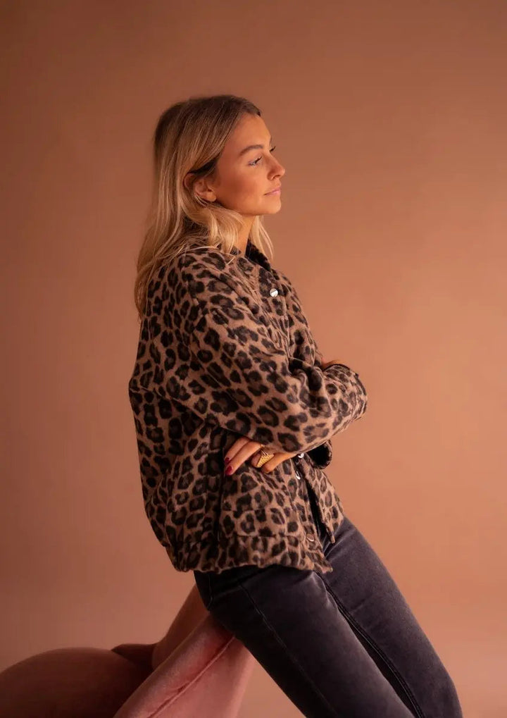 Collarless women's oversized leopard print quilted jacket with press-studs, offering a modern animal print look.