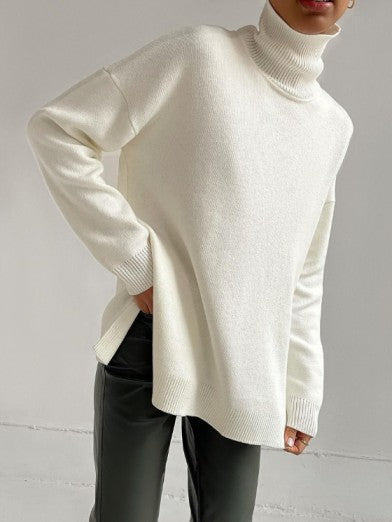 Elegant women's fashion: a long, oversized turtleneck sweater enhanced with a trendy side slit.