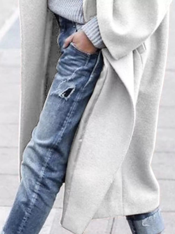 Single-breasted oversized long winter coat for women in black, offering warmth & style.