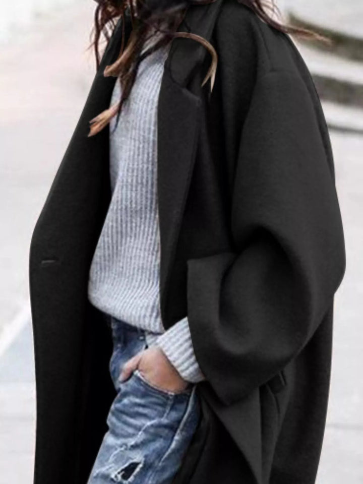 Blue women's oversized long winter coat, relaxed fit stylish jacket for cold days.