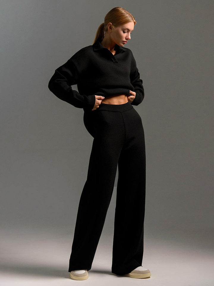 Woman modeling oversized polo lounge set with wide leg trousers, showing its comfortable, chic style.