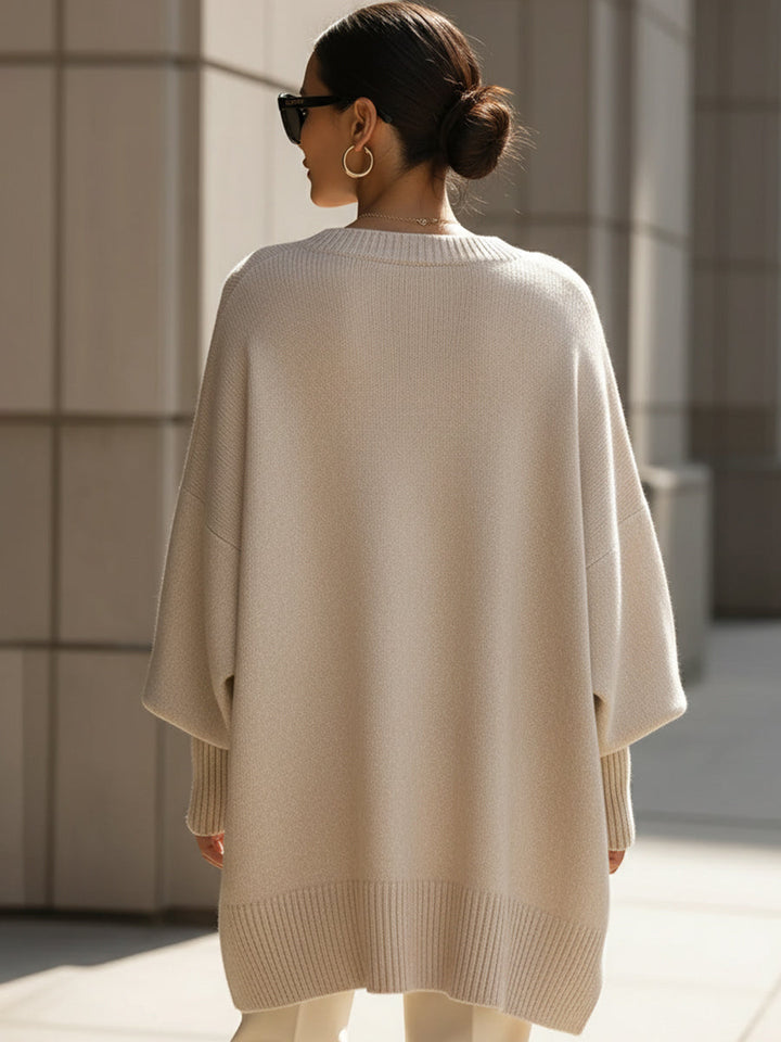 Women's versatile oversized poncho blouse. Perfect long sleeve, round neck top for casual elegant style.