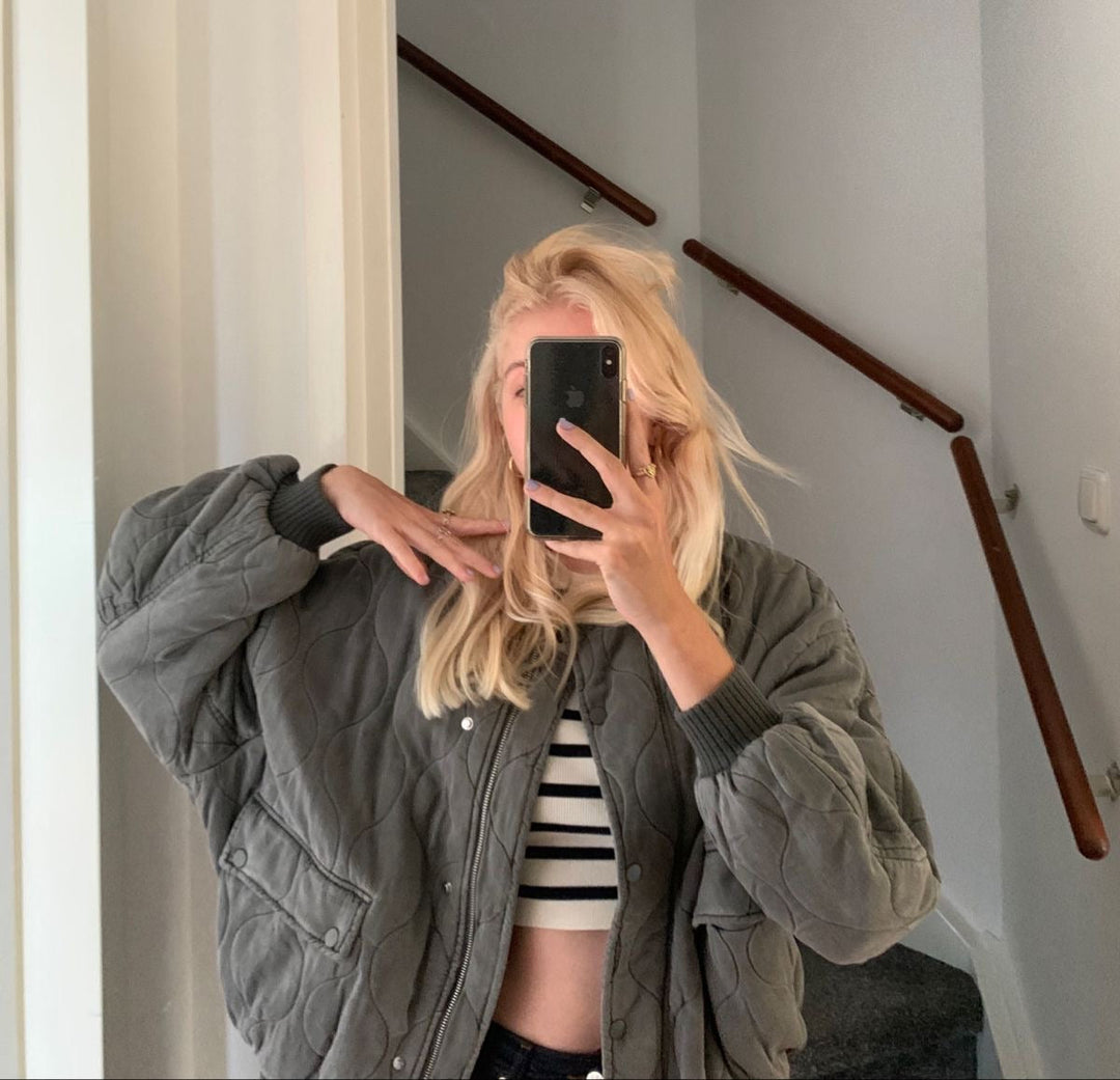 Streetwear-inspired women's oversized quilted bomber, ideal for cool weather fashion.