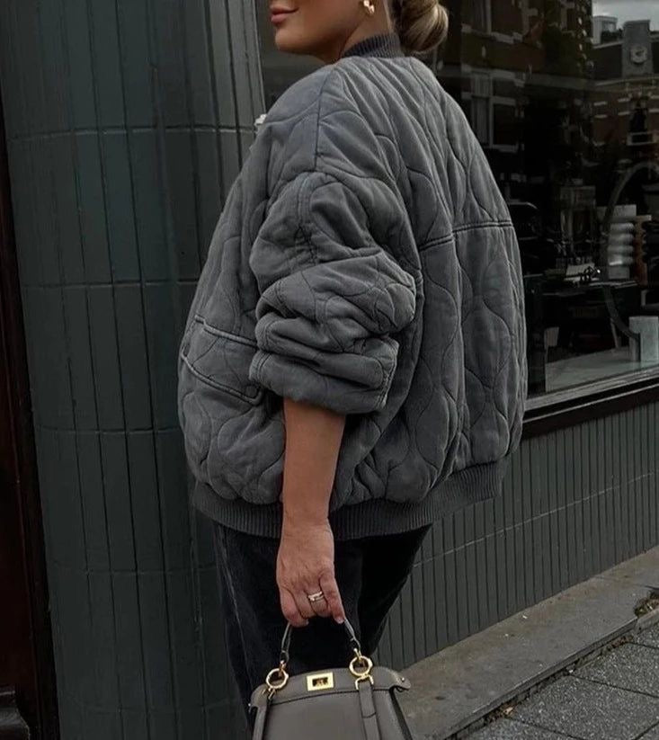 Warm women's oversized quilted bomber jacket, a stylish choice for winter casual wear.