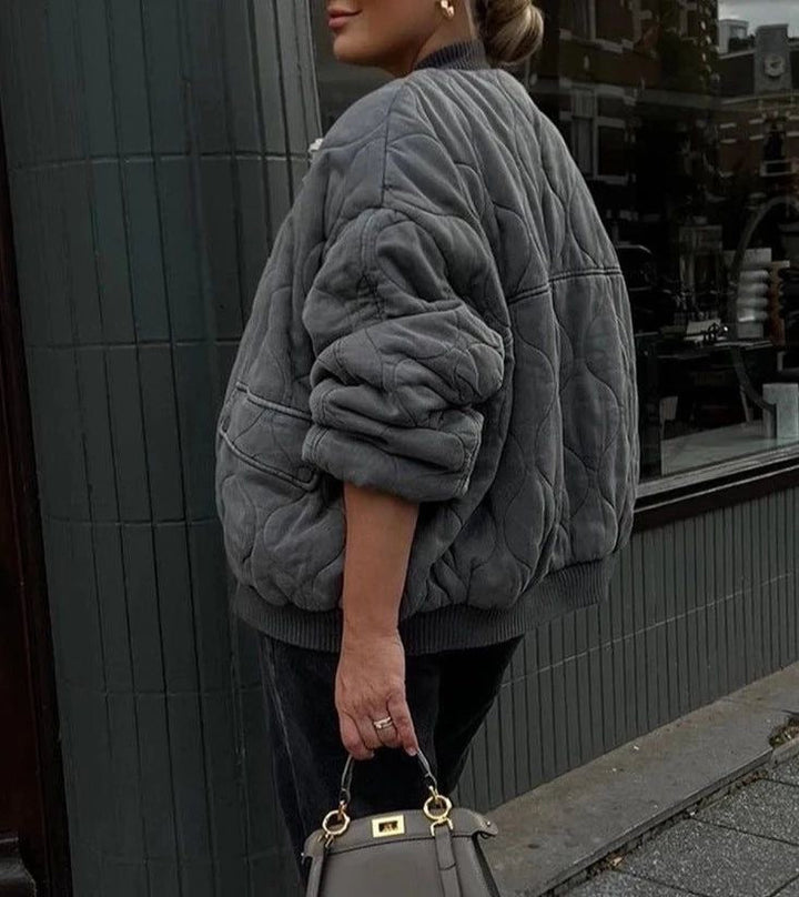 Warm women's oversized quilted bomber jacket, a stylish choice for winter casual wear.