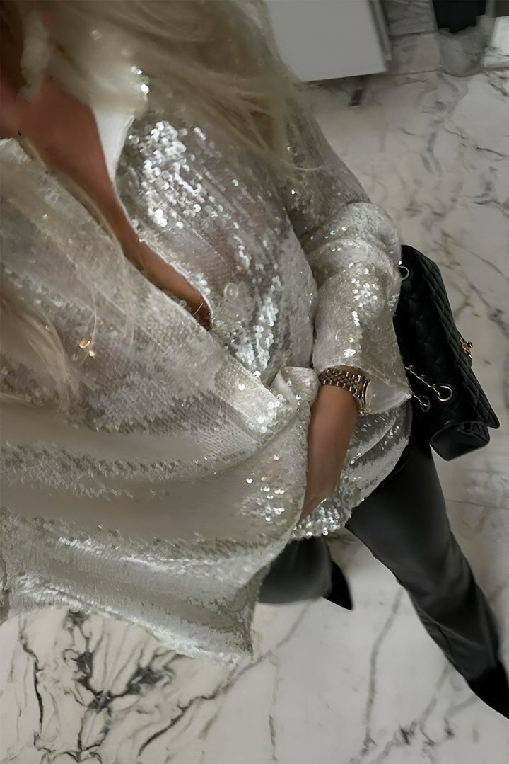 Shimmering oversized sequin mini shirt dress for women. Fashionable button-front, long sleeve party wear.