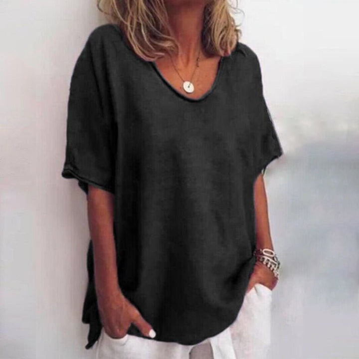 Trendy women's oversized V-neck blouse. Short sleeve design for a relaxed, comfortable & stylish summer top.